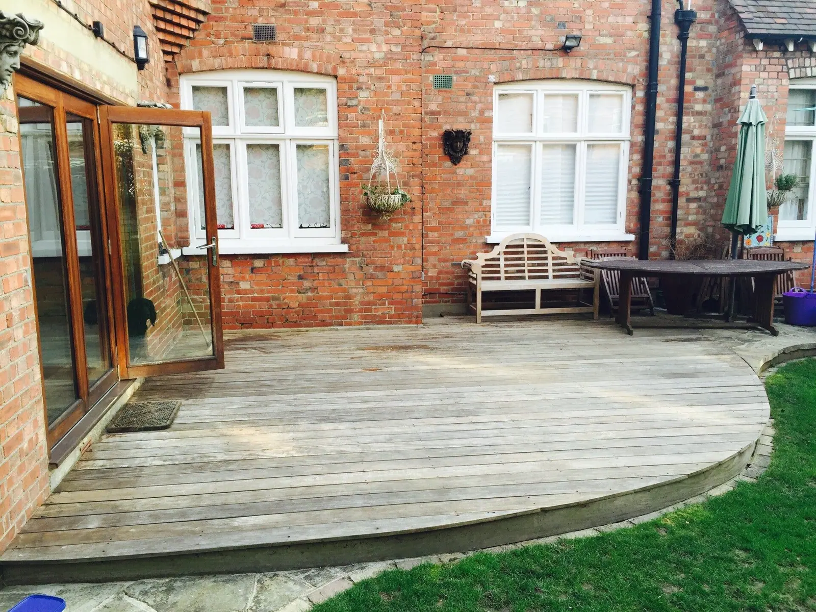 Weathered grey decking before pressure washing