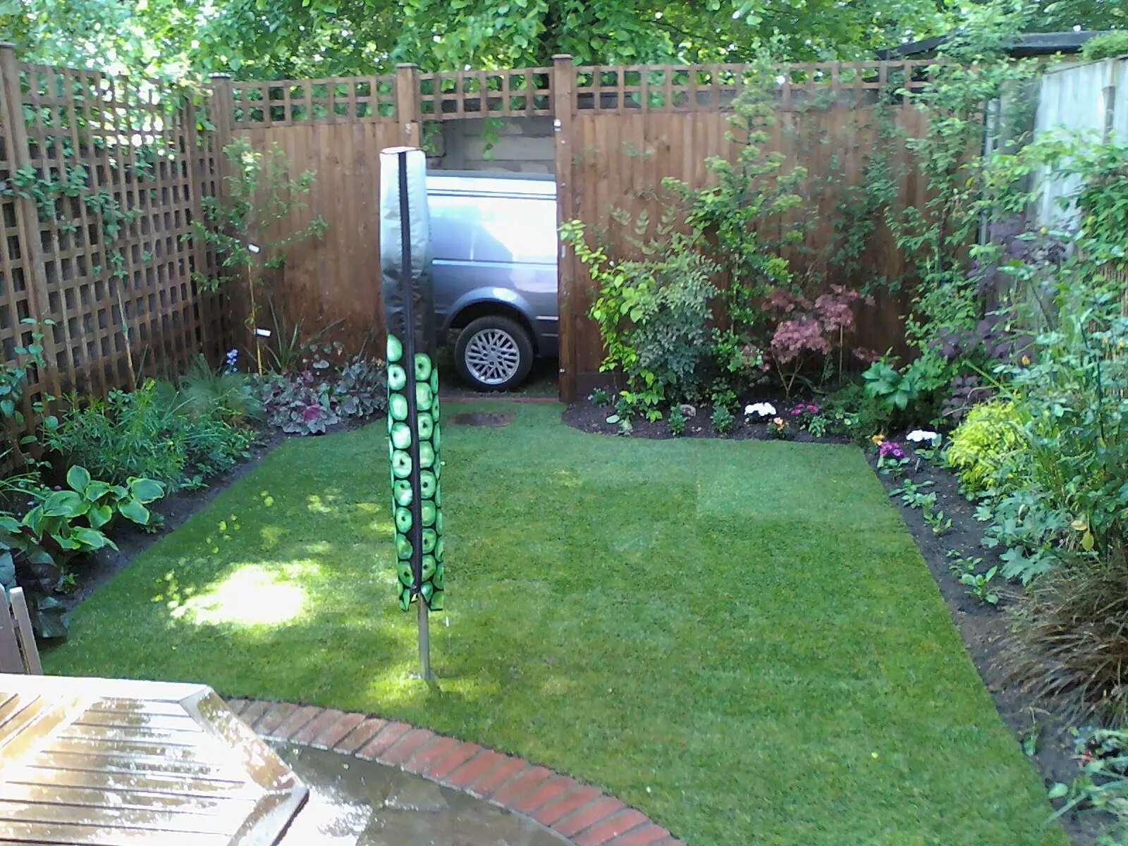 Finished back garden with a new lawn, planted borders and brick edging