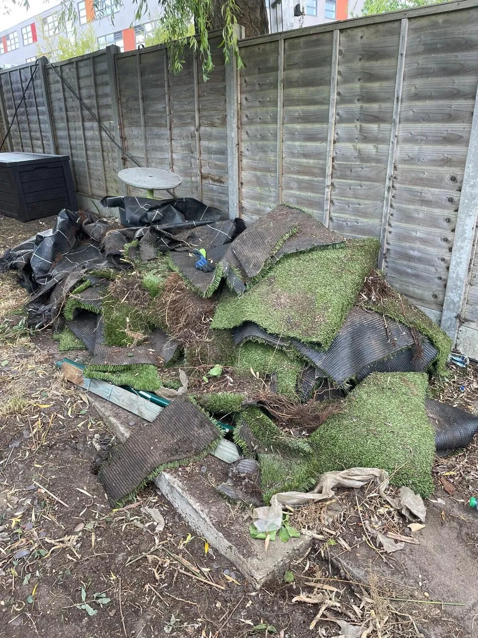 Old artificial grass rolled up for removal