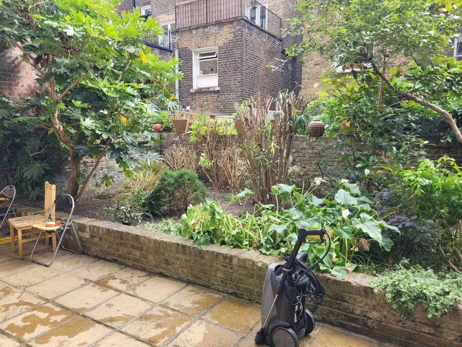 Raised bed and patio tidied, with the border cut back and swept