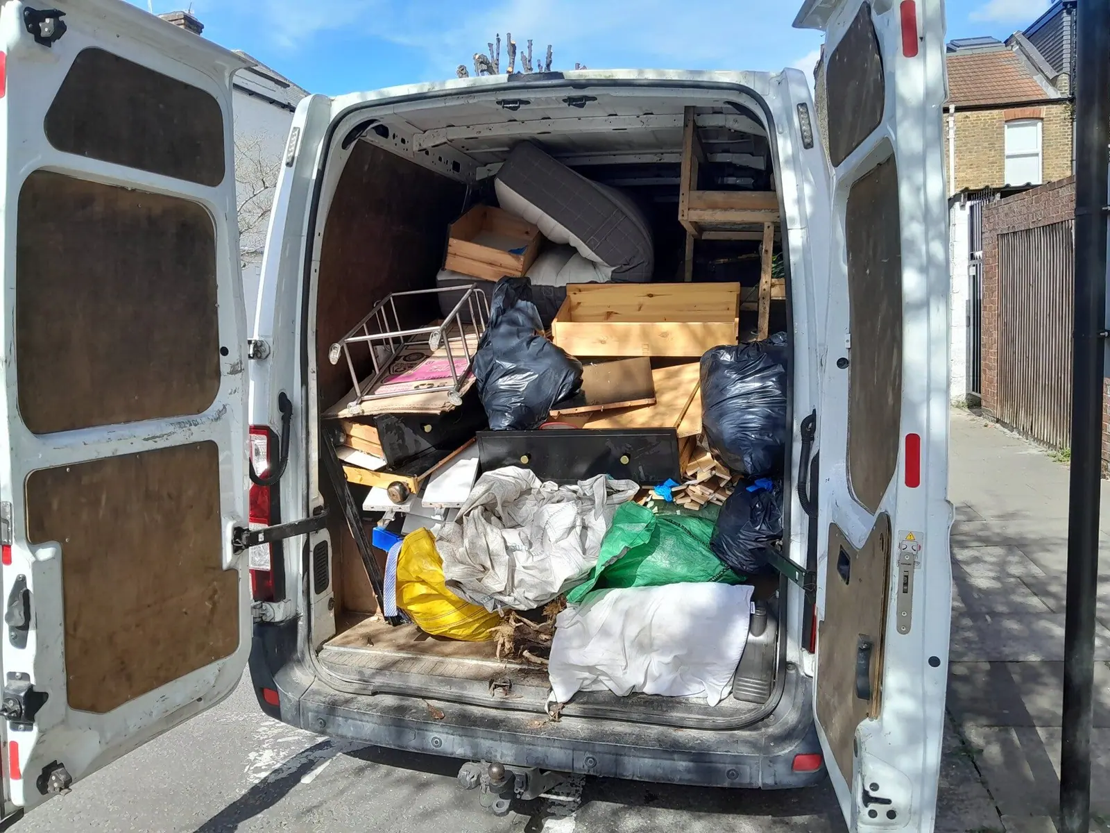 Van loaded with garden rubbish and old furniture for disposal